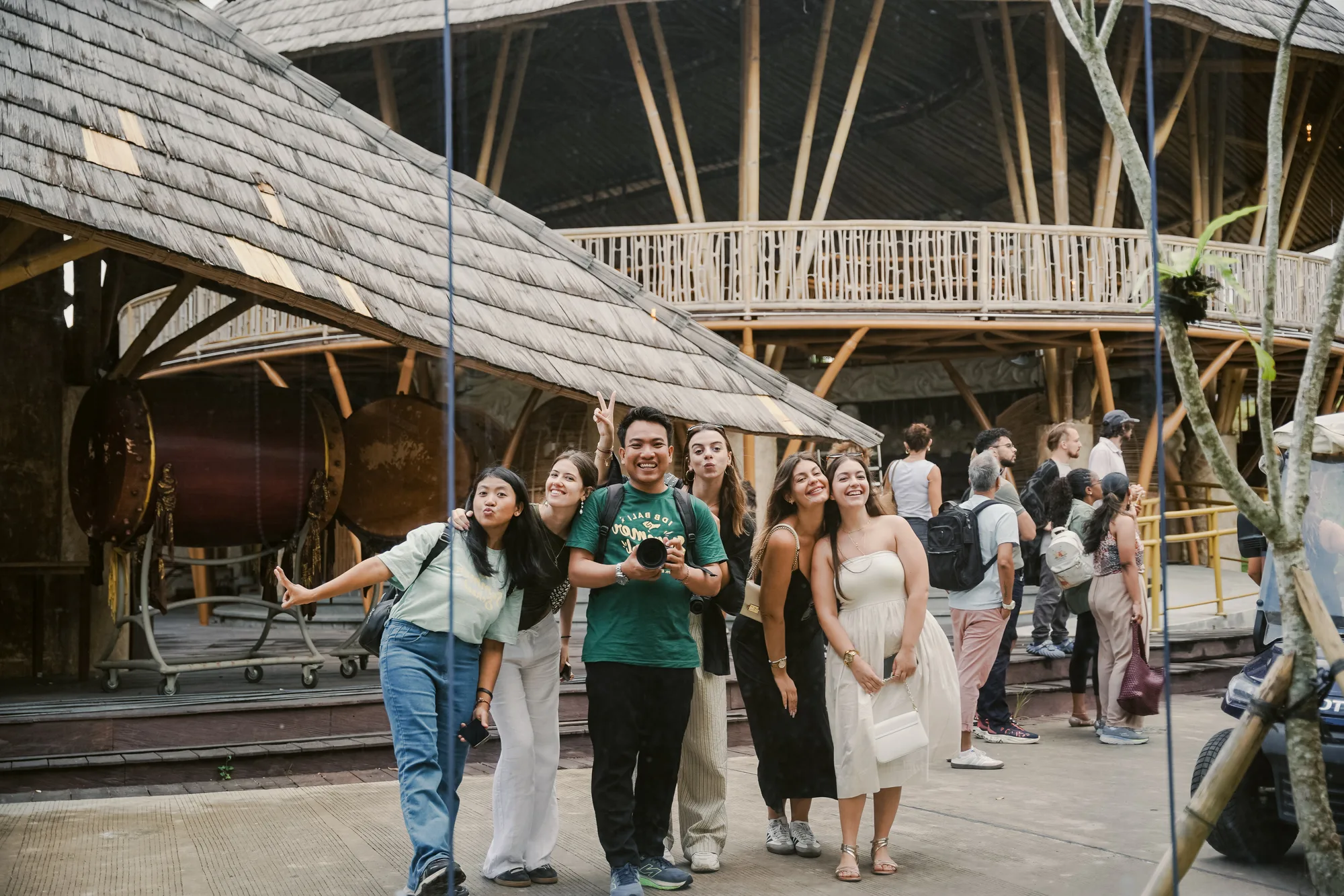A group visiting a bamboo pavilion site in Bali